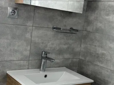 a bathroom sink with a faucet on the wall at 1 Bedroom Cozy Studio in Athens