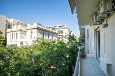 a balcony of a building with trees and buildings at Central Spot 2-Bedroom Apt by ΜΡS in Athens