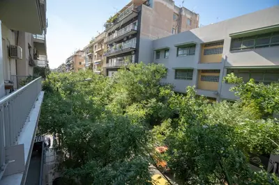 an apartment balcony with trees and buildings at Central Spot 2-Bedroom Apt by ΜΡS in Athens