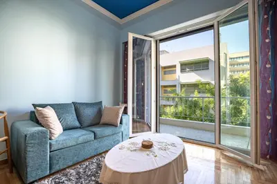 a living room with a couch and a table at Central Spot 2-Bedroom Apt by ΜΡS in Athens