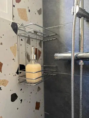 a bathroom with a soap dispenser on a wall at Menta Boho Piraeus Apartment in Piraeus
