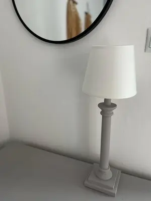 a white lamp sitting on a table in front of a mirror at Menta Boho Piraeus Apartment in Piraeus