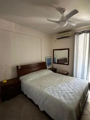 a bedroom with a bed and a ceiling fan at Saronida Beachwalk Stay in Saronida