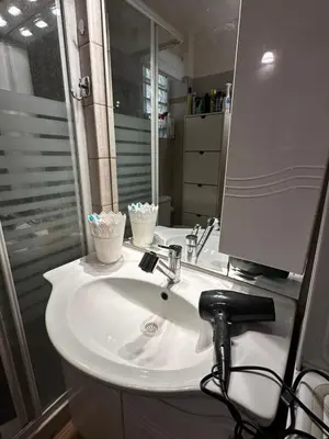 a bathroom with a white sink and a mirror at Saronida Beachwalk Stay in Saronida