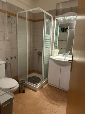 a bathroom with a shower and a toilet and a sink at Saronida Beachwalk Stay in Saronida