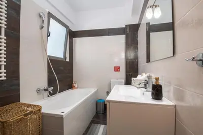 a bathroom with a tub and a sink and a bath tub at Villa Anavil - Boutique Coastal Retreat in Varkiza in Vari