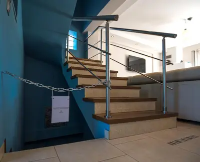 a staircase in a building with a blue wall at Villa Anavil - Boutique Coastal Retreat in Varkiza in Vari