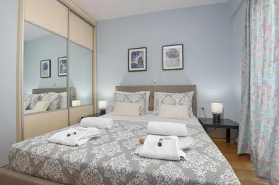 a bedroom with a large bed with towels on it at Villa Anavil - Boutique Coastal Retreat in Varkiza in Vari