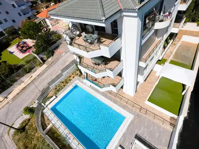 an aerial view of a house with a swimming pool at Costa Voula Shared Pool & Beach Apartment A2 in Athens