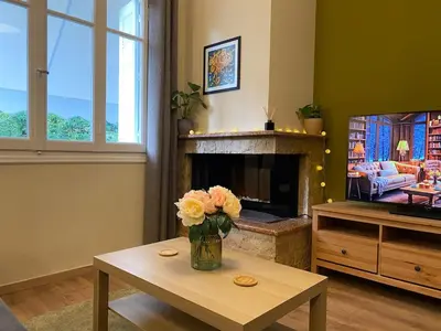 a living room with a vase of flowers on a table at Cozy Acropolis backyard haven in Athens