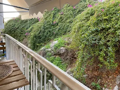 a staircase leading up to a hill with flowers at Cozy Acropolis backyard haven in Athens