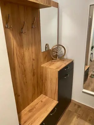 a wooden cabinet with a mirror in a room at Cozy Acropolis backyard haven in Athens