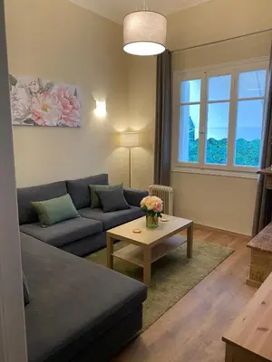 a living room with a couch and a table at Cozy Acropolis backyard haven in Athens