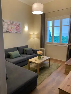 a living room with a couch and a table at Cozy Acropolis backyard haven in Athens