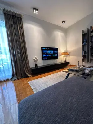 a living room with a flat screen tv on a wall at Etherion Luxury Rooftop Balcony Penthouse in Athens in Athens