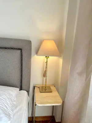 a lamp on a table next to a bed at Etherion Luxury Rooftop Balcony Penthouse in Athens in Athens
