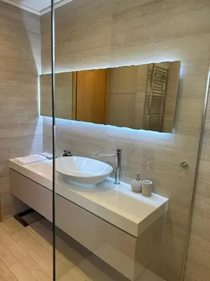 a bathroom with a sink and a mirror at Etherion Luxury Rooftop Balcony Penthouse in Athens in Athens