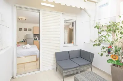 a small room with a bed and a blue chair at Cozy 6th floor, city center, 30m2, sun terrace in Athens