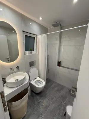 a bathroom with a toilet and a sink and a mirror at Andys house in Athens