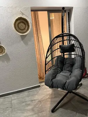 a black chair sitting in front of a door at Andys house in Athens