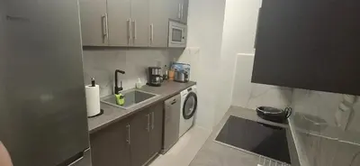 a small kitchen with a sink and a washing machine at Glyfada31 near center in Athens