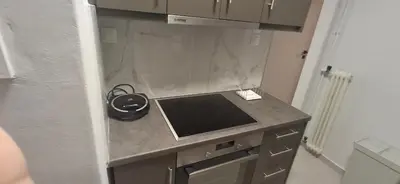 a small kitchen with a counter top with a stove at Glyfada31 near center in Athens
