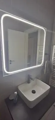 a bathroom with a white sink and a mirror at Glyfada31 near center in Athens