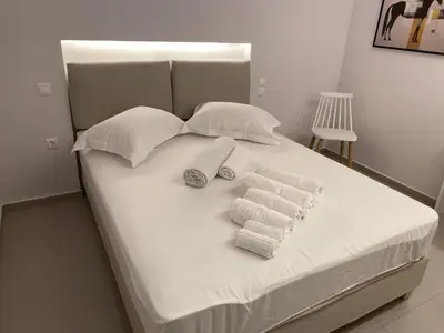 a white bed with towels on top of it at Erexthion Diony1 Apartment in Athens