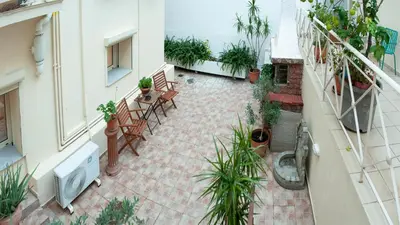 an apartment patio with plants and a table and chairs at Erexthion Diony1 Apartment in Athens