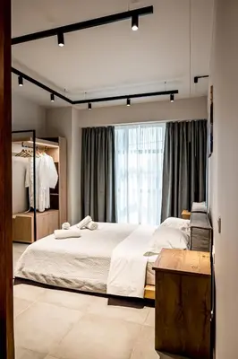 a bedroom with a large bed and a window at Shiny Santorini Apartment in Piraeus