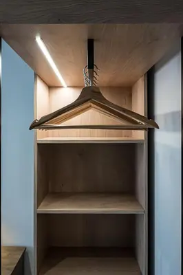 a wooden shelf in a cupboard with a hood at Shiny Santorini Apartment in Piraeus