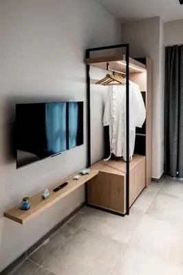a dressing room with a mirror and a tv at Shiny Santorini Apartment in Piraeus