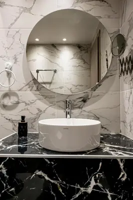 a bathroom with a sink and a mirror at Shiny Santorini Apartment in Piraeus