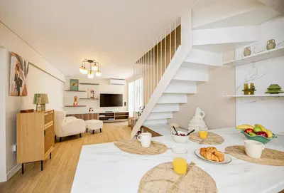a living room with a table with food on it at Coastal Charm by Neuvel in Athens