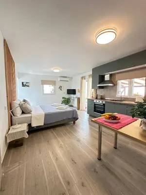 a large bedroom with a bed and a kitchen at Rooftop in Psyrri- 360 Athens view in Athens