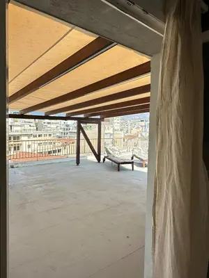 a view from the roof of a building with a bench at Rooftop in Psyrri- 360 Athens view in Athens