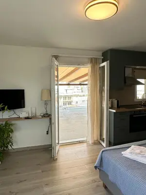a bedroom with a door open to a kitchen at Rooftop in Psyrri- 360 Athens view in Athens