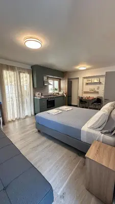 a bedroom with a large bed and a kitchen at Rooftop in Psyrri- 360 Athens view in Athens