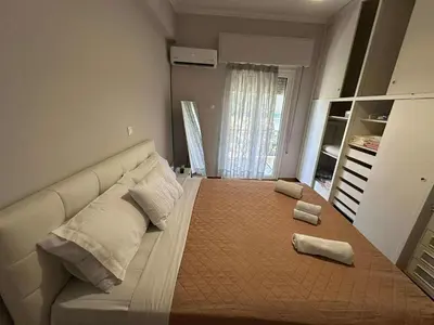 a bedroom with a large bed with two towels on it at The Athenian Spot in Athens