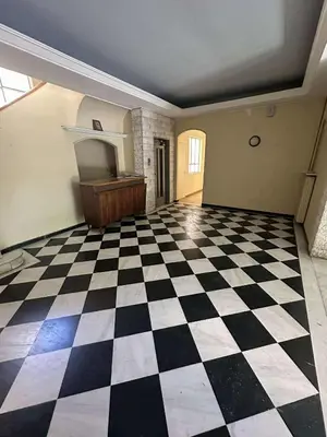 an empty room with a checkered floor and a piano at The Athenian Spot in Athens