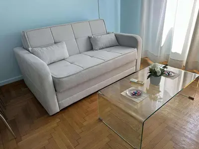 a living room with a couch and a coffee table at The Athenian Spot in Athens