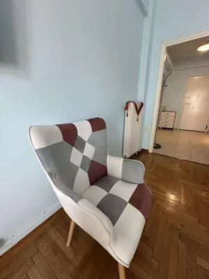 a chair sitting in a room with a hallway at The Athenian Spot in Athens