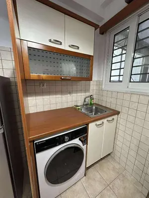 a kitchen with a sink and a washing machine at The Athenian Spot in Athens