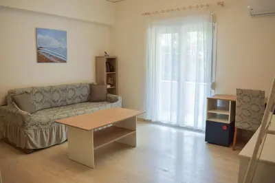 a living room with a couch and a table at Sofia's Urban Flat - Near Tram in Athens