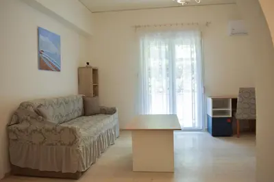 a living room with a couch and a table at Sofia's Urban Flat - Near Tram in Athens
