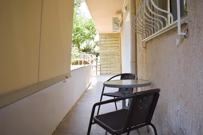 two chairs and a table in an empty hallway at Sofia's Urban Flat - Near Tram in Athens