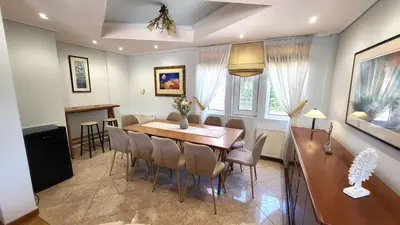 a dining room with a table and chairs at Luxury villa Espera Lagonisi with private pool in Kalívia Thorikoú