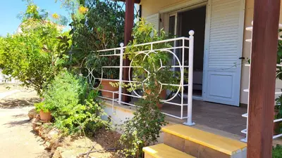 a porch with a white gate and a wooden bench at Luxury villa Espera Lagonisi with private pool in Kalívia Thorikoú