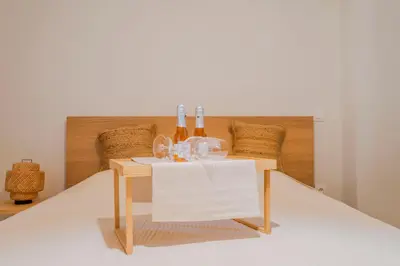 a table with bottles and glasses on top of it at Sefis apartment in Athens
