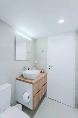 a bathroom with a sink and a toilet and a mirror at Sefis apartment in Athens
